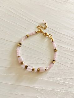 Madagascar rose quartz bracelet.  Beautiful elegant bracelet consists of high quality faceted natural rose quartz and 18 k. gold filled beads.  Rose quartz is love stone- self love, joy, inner peace, connection matters of the heart. Bracelet is assembled on a very durable jewelry wire. Length is adjustable 6.3 inches +2 in. extension chain. Nickel free stainless steel lobster clasp This bracelet is perfect to wear on its own, but also will be great layered combinations. Great gift idea for women Gold Rose Quartz Bracelets For Jewelry Making, Gold Bracelets With Rose Quartz And Natural Stones, Adjustable Rose Quartz Bracelet With Faceted Beads, Adjustable Faceted Rose Gold Bracelet, Rose Quartz Beaded Bracelet With Faceted Beads As Gift, Handmade Dainty Rose Quartz Beaded Bracelets, Rose Gold Beaded Bracelets With Gemstone Beads, Gold Beaded Bracelets With Rose Quartz, Gold Beaded Bracelets With Rose Quartz Round Beads