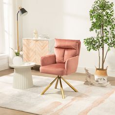 a living room with a pink chair and potted plant