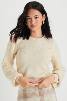 The Lulus Undeniable Glow Ivory Pearl Pullover Sweater will be your favorite way to make yourself shine this holiday season! This stunning sweater has a slightly fuzzy medium-gauge knit construction, with gleaming faux pearl details throughout, that shapes a classic crew neckline, long balloon-style sleeves with fitted cuffs, and a relaxed bodice. Contrasting ribbed knit accents the neckline, cuffs, and hem. Fit: This garment fits true to size. Length: Size medium measures 17.75" from shoulder t Beige Winter Party Sweater, Cream Winter Party Top, Cream Party Tops For Winter, Elegant Cream Knit Top For Winter, Winter Cream Crew Neck Knit Top, Cream Crew Neck Knit Top For Winter, Pearl Sweater Outfit, Sweaters For Women Knit, Fancy Sweater