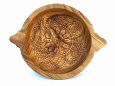 a wooden bowl with an intricate design on it