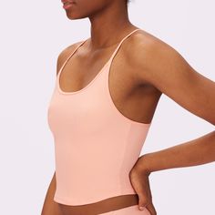 Our best-selling base layer now with a sexy racer back. Layer this tank or wear it soloÃ¢â‚¬Å¡Ãƒâ€žÃƒ ¶Ã¢Ë†Å¡Ãƒâ€˜Ã¢Ë†Å¡Ãƒâ€ our soothing universal fabric disappears under clothes and molds to the shape of your body. Now in Peach Jelly <3 Workout Top With Built-in Bra And Second-skin Fit, Solid Color Summer Racerback Sports Bra, Pink High Stretch Crop Top With Built-in Bra, Pink Crop Top With Built-in Bra And High Stretch, Pink High Stretch Seamless Top, Fitted Pink Tank Top With Built-in Bra, Second-skin Tank Top With Built-in Bra For Workout, Bra-friendly Racerback Camisole In Solid Color, Summer Racerback Crop Top For Pilates