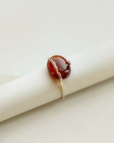 A limited edition garnet ring with a natural ethically sourced cinnamon red hessonite garnet set in yellow gold. The oval garnet cabochon is set in a unique band and prong setting to better showcase the beauty of the stone. Each ring is completely handmade in our studio using traditional goldsmithing techniques exclusively. Available in 9k & 18k solid yellow gold. Hessonite garnet: app. 14mm, app. 7cts, light blue, ethically sourced, origin: Central African Republic Band Width: 1.3mm, recycled g Garnet Ring For Men, Modern Garnet Ring, Oval Cabochon Ring, Oval Stone Ring Design, Gernet Ring, Statement Garnet Ring, Unique Stone Rings, Oval Stone Rings, Hessonite Ring