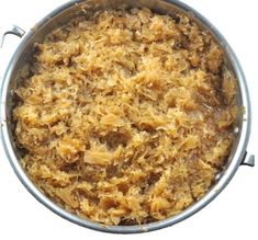 a large pot filled with food on top of a wooden table