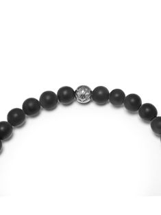 6mm Matte Onyx Beads Black CZ Diamond Bead Handmade in Los Angeles Product Code: MCHCO_084 This bracelet is strung on an elastic strand that easily slips on your wrist. The elastic strand is stretchy and will stretch like a rubber band when slipped on and off. Our durable elastic cord is covered in strong silicone and will permanently keep its soft elasticity. Designer's Notes Strung by hand from Matte Onyx beads and punctuated with our Black and White CZ Diamond Bead, you can't go wrong with th Black Faceted Spiritual Beads, Adjustable Black Gemstone Beaded Bracelets, Adjustable Black Wristband With Round Beads, Adjustable Round Onyx Beaded Bracelet, Adjustable Onyx Beaded Bracelet, Silver Stretch Bracelet With Black Beads, Silver Onyx Beaded Bracelets Hand-strung, Classic Onyx Beaded Bracelets With Adjustable Fit, Black Adjustable Stretch Bracelet With Gemstone Beads