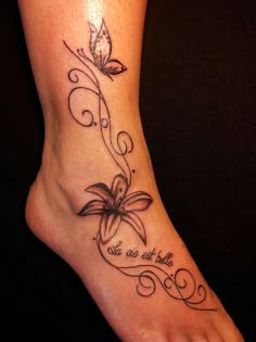 a woman's foot with a flower tattoo on it