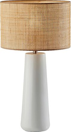 a white table lamp with a beige shade on it's base and a light brown drum