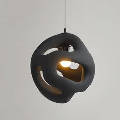 a light that is hanging from a wire with an object in the middle of it