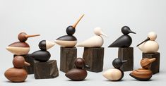 a group of wooden birds sitting on top of each other