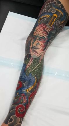 a person with tattoos on their arm and leg