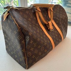 Authentic Louis Vuitton M41424 Keepall 55; Includes Original Lock And Keys In Box Good Used Condition. No Visible Rips Or Tears. Includes Lock And Key Current Msrp: $2,170.00 Date Code: Sd1004 (The Date Code Indicates A Production Date Of: October 2004 In France Or The United States (After 1995)) Condition: Monogram Canvas In Very Good Shape; No Rips Or Holes; Vibrant Monogram Print Color; Clean Interior And No Foul Odor; Zipper Works Perfectly; Excellent Hardwares; Beautiful Light Honey Patina Color Throughout Leather; Minimal Hairline Scratches And Stains On Leather Handle And Trims Minor Scratches On Leather Pipings; 8/10 Overall Condition Product Details From Website: The Keepall Everyday Luxury Bags With Leather And Monogram Canvas, Luxury Everyday Monogram Canvas Bag With Leather Trim, Luxury Pre-owned Brown Bag, Pre-owned Designer Brown Bags, Designer Brown Travel Bag With Leather Handles, Brown Leather Trim Bag For Everyday Luxury, Designer Monogram Canvas Travel Bag For Everyday Use, Brown Monogram Canvas Travel Bag With Leather Trim, Designer Brown Coated Canvas Travel Bag