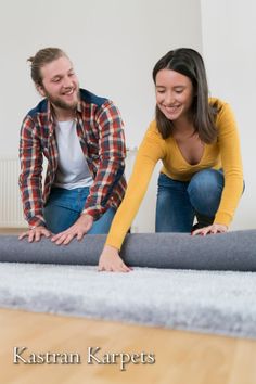 a man and woman laying on top of a mattress in the middle of a room