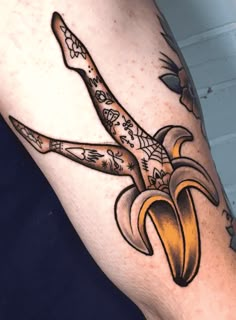 a tattoo on the leg of a person with a banana