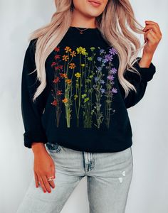 This beautiful subtle gay pride sweatshirt with its delicate and colorful wildflowers is soon to become your new favorite!  Want a different design or color? Just let us know and we'll make it happen!  FIT & SIZING: * Ideal for any situation, this unisex heavy blend crewneck sweatshirt is pure comfort.  * Sweatshirts are comfortable for both men and women. * Please see the size chart in the photos to obtain an accurate size. Measure one of your favorite sweatshirts for comparison! * Ladies: For a looser fit, order one size up. GARMENT FEATURES: * These garments are made from polyester and cotton. This combination helps designs come out looking fresh and beautiful.  * The collar is ribbed knit, so it retains its shape even after washing. There are no itchy side seams on these sweaters. * Sw Pride Outfit, Flower Shirt, Gay Pride, Pride Shirts, Wild Flowers, Sweat Shirt, Colorful Shirts, Crew Neck Sweatshirt, Favorite Outfit