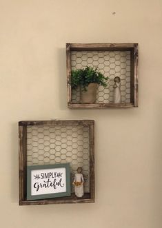 two small wooden shelves with plants in them on the wall next to a sign that says simply grateful