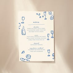 a blue and white menu with wine glasses on it