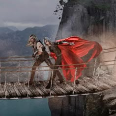 two women in costumes walking across a bridge