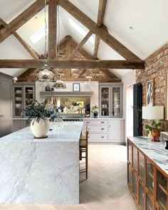 a large kitchen with an island in the middle and lots of counter space on one side