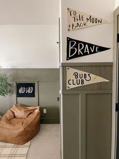 a room that has some signs on the wall and a bean bag chair in it