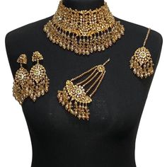 Asian jewellery set. Set includes- Necklace  Earrings  Jhumar  Tikka Gold Bridal Necklace With Stone Work For Festive Occasions, Gold Jewelry With Stone Work For Festivals, Festive Heavy Gold Kundan Necklace, Gold Kundan Necklace With Stone Work For Festivals, Gold Heavy Kundan Necklace For Diwali, Heavy Gold Kundan Bridal Necklace, Heavy Gold Kundan Necklace For Diwali, Gold Kundan Necklace For Wedding And Diwali, Gold Meenakari Chandbali Jewelry Sets