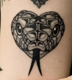 a heart shaped tattoo with scissors sticking out of it