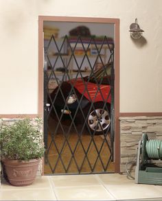 A folding steel gate is an affordable and functional way to secure various openings. The accordion gate expands up to 52-in. wide and mounts left or right within the opening or on the surface. Holes are pre-drilled for a padlock. Hinges allow the gate to swing out for full access to the opening when needed. The powder coated finish keeps the gate maintenance free. RELIABILT 48-in x 80-in Black Steel Recessed or Surface Mount Universal/Reversible Security Door | 9154805-RB Burglar Proof, Steel Security Doors, Door Sweep, Security Doors, Modern Barn Door, Steel Gate, Door Manufacturer, Modern Barn, Iron Gate