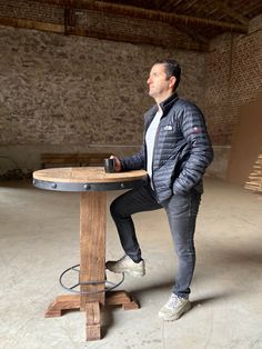 a man sitting at a table with his legs crossed