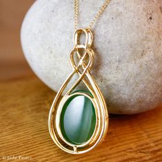 "Here is a beautiful translucent large oval green nephrite jade pendant set with pave diamonds in solid 18KT yellow gold. The jade is set in a double infinity love knott halo setting and is surrounded by pave set round diamonds. The jade is about 14x18mm and is approx. 14.45 carats. The total weight of the brilliant cut round white diamonds is 0.49 carats. The pendant is about 1 1/2\" long. The chain is 14KT gold and is 16\" long. If you do not want the chain, please convo us and we will adjust Elegant Oval Jade Jewelry, Oval Cabochon Jade Jewelry Gift, Elegant Oval Cabochon Jade Jewelry, Double Infinity, Infinity Love, Lucky Green, Nephrite Jade, Halo Setting, Wedding Necklaces