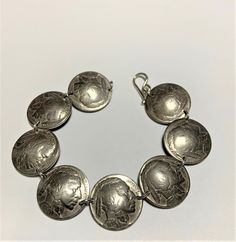 Coins - Vintage Buffalo Nickle Coin Bracelet Sterling Silver Links. Sterling silver links & clasp. Fits wrist size 7 inches. Larger sizes available. Feel free to ask for a size larger than what is listed. Antique Silver Nickel-free Bangle Bracelet, Antique Adjustable Nickel-free Jewelry, Antique Silver Round Bracelet For Gift, Antique Silver Round Bracelets For Gift, Antique Silver Sterling Bracelet Nickel-free, Sterling Silver Round Stamped Bracelet, Nickel-free Antique Silver Sterling Bracelet As A Gift, Nickel-free Antique Silver Sterling Silver Bracelet For Gift, Nickel-free Antique Silver Sterling Silver Bracelet