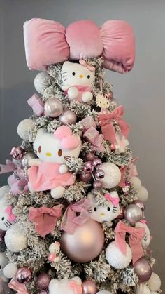 a hello kitty christmas tree with pink and silver ornaments