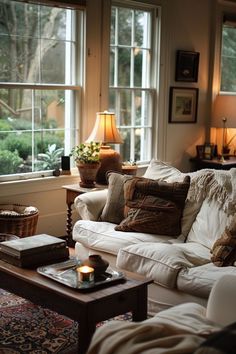 a living room filled with lots of furniture next to two windows and a coffee table