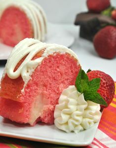 a piece of cake with white frosting and strawberries