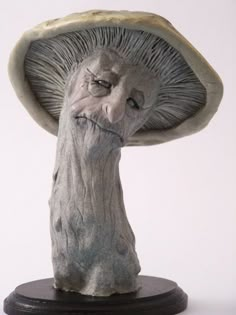 a statue of a mushroom with its head in the air and it's mouth open