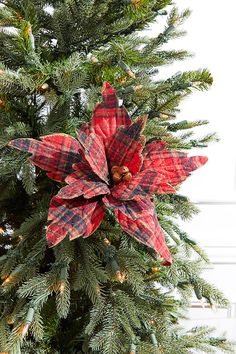 a christmas tree with red and black plaid poinsettia