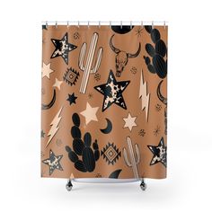 a brown shower curtain with black and white stars, cacti, and cactuses