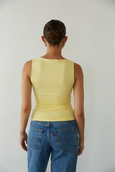 The Rylee Ruched Boat Neck Top is a ray of sunshine! This summer top features butter soft fabric, flattering side ruching, and a trendy boat neckline! Available in Butter Yellow; pair this top with your go-to denim to complete the look! Details: 95% Polyester, 5% Spandex Lots of Stretch Fully Lined Hand Wash Cold/ Line Dry Sleeveless Summer Tops With Ruched Back, Chic Summer Tops With Ruched Back, Fitted Casual Top With Ruched Back, Casual Fitted Top With Ruched Back, Summer Tops With Ruched Back, Summer Tops With Ruched Sides And Elastane, Summer Fitted Ruched Top, Sleeveless Ruched Back Top, Sleeveless Elastane Top With Ruched Back