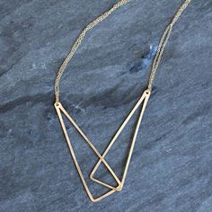 This gracefully geometric necklace features two long linked triangles strung on a double layer of delicate lacy chains. The center pendant feature elegantly accentuates the line along the collarbone. The combination or geometric edges and organic elements make this piece ideally suited to compliment any clothing style. Available in either 18 or 20 inch lengths Metal choices include sterling silver, 14k gold fill, or mixed metals. All Rebecca Haas Jewelry is handcrafted by me in my Southern Vermont Studio from recycled and ethically sourced materials. Modern Sterling Silver Double Chain Necklaces, Modern Sterling Silver Necklaces With Double Chain, Modern Sterling Silver Double Chain Necklace, Modern Double Strand Necklace With Delicate Chain, Modern Long Necklace For Layering, Modern Double Strand Necklace With Adjustable Chain, Modern Double Strand Everyday Necklaces, Modern Double Strand Necklace For Everyday, Modern Pendant Necklaces For Layering