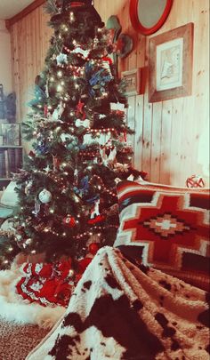 a christmas tree is decorated with red, white and blue ornaments