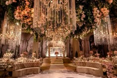 an elaborate wedding setup with flowers and chandeliers