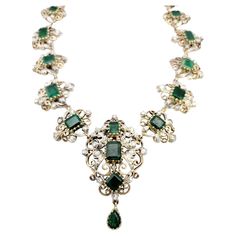 Transport yourself to a world of timeless beauty and sophistication with this extraordinary antique Victorian era graduated necklace. Adorned with mesmerizing emeralds and dazzling diamonds, this exquisite piece captures the essence of a bygone era. The necklace showcases a captivating arrangement of graduated emerald gemstones, carefully selected for their rich green color and exquisite clarity. Each emerald is meticulously set in an intricate scroll motif link crafted from lustrous 14K yellow Luxury Victorian Flower Pendant Jewelry, Luxury Antique Jewelry With Rectangular Stone, Luxury Vintage Rose Cut Diamond Necklace, Ceremonial Elegant Jeweled Necklaces, Elegant Emerald Jewelry With Rose Cut Diamonds, Elegant Emerald Bridal Necklace With Intricate Design, Elegant Bridal Emerald Necklace With Intricate Design, Elegant Emerald Necklaces With Intricate Design, Elegant Ceremonial Emerald Necklace With 17 Jewels