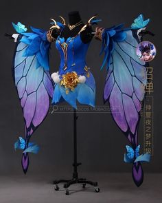 a blue and purple costume with wings on top of a mannequins head