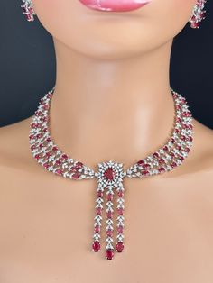 Dazzle on Your Special Day: Handcrafted Ruby CZ Diamond Necklace for Brides Welcome to the world of timeless elegance and radiant beauty. Our Ruby CZ Diamond Necklace is a masterpiece designed to make every bride feel like royalty on her wedding day. Each necklace is meticulously handcrafted, ensuring a touch of personalized charm in every piece. With its captivating sparkle and luxurious design, this necklace promises to be the centerpiece of your bridal ensemble, leaving an impression that las Wedding Crystal Necklace With Brilliant Cut, Fine Jewelry Crystal Bridal Necklace For Wedding, Fine Crystal Bridal Necklace For Wedding, Crystal Bridal Necklace For Wedding, White Gold Ruby Necklace For Party, Party Ruby Necklace In White Gold, Round Fine Jewelry Bridal Necklace For Wedding, Fine Jewelry Wedding Necklace With Sparkling Stones, Exquisite Cubic Zirconia Wedding Necklaces