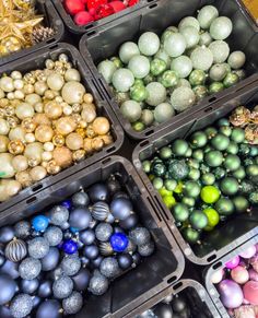 many different colored ornaments in plastic containers