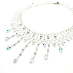 This Beaded Swarovski Crystal and Pearl Bridal Statement Necklace is a collar style with gorgeous teardrop pendants. It is and one of a kind.  All My pieces are made with the finest materials available. I only use genuine Swarovski Crystals and Pearls. They are strung on Fireline which is knotted throughout the piece. Sterling silver or gold filled clasps are standard making my pieces heirloom quality to be handed down to future brides. I used 6 and 4 mm white Swarovski Pearls, 6 and 4 mm Clear AB Swarovski bicones, 9 mm teardrop crystals, white pearl finish seed beads and a sterling clasp. This took 10 hours to make but the finished product is sooo worth it! If you want to make a statement, this is your piece. This is the one and only piece exactly like this and is ready to ship now. I wi Beaded Teardrop Wedding Jewelry, Elegant Beaded Drop Necklace, Silver Beaded Necklace With Dangling Beads For Wedding, Elegant Teardrop Dangling Beads Necklaces, Elegant Teardrop Necklaces With Dangling Beads, Handmade Dangle Pearl Necklace For Wedding, Handmade White Crystal Necklaces For Wedding, Elegant Teardrop Necklace With Dangling Beads, Elegant Teardrop Dangling Beads Necklace