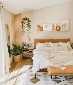 a bed room with a neatly made bed and lots of plants on the wall above it