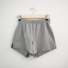 Description: 1990s gray cotton blend knit athletic shorts. Elastic waist. Side vent slits at hems.  Condition: In great condition, with no holes or stains. Laundered.  Designer: n/a Stated size: n/a  Measurements:  Circumference at hem: 21"  Inseam: 3"  Rise: 12"  Overall length: 11.5"  Waist: 24 - 30"  Hips: up to 37"  ---> If you need an order shipped by a particular date or shipped via a quicker method, please ask PRIOR to purchase to see if we can accommodate that request. Visit the rest of Black Swimsuit Cover Up, Sewing Tape Measure, Strapless Evening Gowns, Black Swimsuit, Circle Skirt, Grey Cotton, Corduroy Pants, Athletic Shorts, Stripe Sweater