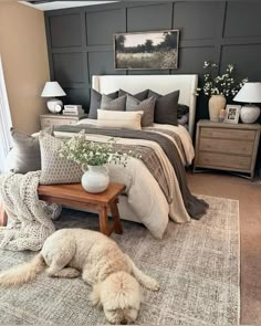 a dog laying on top of a rug next to a bed in a room with gray walls