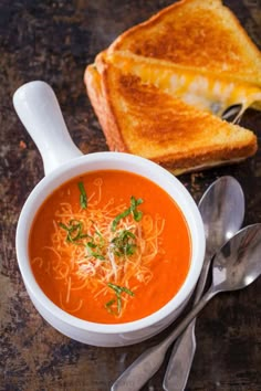 a bowl of tomato soup with toast on the side