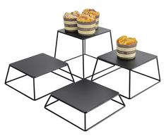 three tiered trays with food on them, one is black and the other is white