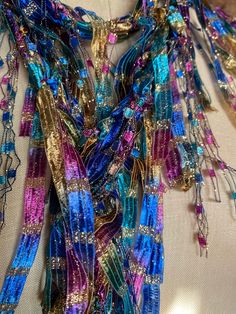 Multicolor scarf for women. Unique scarf handmade for women. Boho scarf for festivals and formal gatherings. Stunning color combination with gold makes this a showstopper. Fuchsia, royal blue, teal green, brass gold with lot of gold metallic sparkle, if you love lot of bling and color this is the accessory for you.  Wear it with matching color jewelry to complete your look. Very rich looking scarf. Masquerade ball comes mind with this color combination. Hand wash in lukewarm water with mild soap, don't rub or wring, squeeze of excess water and hang to dry.  Comes with nice organza satchel for traveling or gift giving. Store the ribbon scarves flat in a drawer or hang them up.  Handmade in United States of America.  Visit the store front at  www.Etsy.com/shop/thinkerbella for more color and Elegant Multicolor One-size Shawl, Handmade Multicolor Scarves For Festivals, Festive Shawl Scarf For Party, Festive Party Shawl Scarf, Multicolor Festival Shawl Scarf, Multicolor Shawl Scarf For Festivals, Multicolor Shawl Scarves For Festivals, Traditional Scarves For Festivals As Gifts, Traditional Scarf For Festivals As A Gift