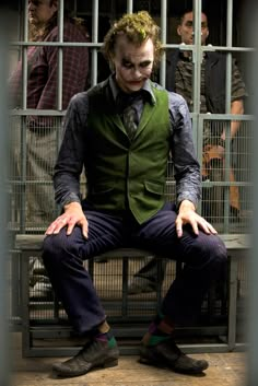 the joker is sitting in his jail cell